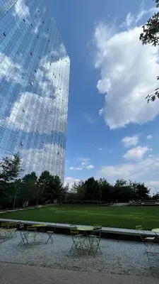 a glass building with tables and chairs in front of it at Luxury 2 bedrooms 2 bathrooms Corner Apartment Breathtaking City Views Modern Retreat in Sunnyside