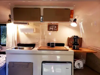 an rv kitchen with a counter and a sink at Unique Caravan for Vintage Glamping Experience in Pine Bush, New York in Pine Bush