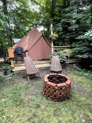 a fire pit and two chairs and a tent at Romantic Botanical Bell Tent for a Fantastic Glamping Experience in Southbury, Connecticut in Southbury