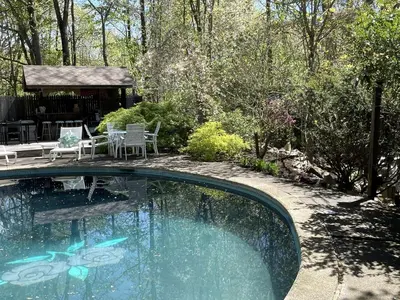 a swimming pool in a yard with a table and chairs at Romantic Botanical Bell Tent for a Fantastic Glamping Experience in Southbury, Connecticut in Southbury
