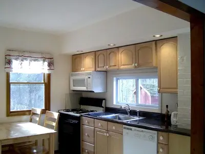 a kitchen with a sink and a stove top oven at Lovely Cottage Getaway in the Mountains near Phoenicia, New York in Chichester