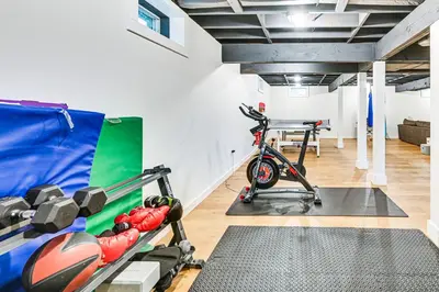 a room with a gym with a bike in it at 8 Mi to Tanglewood and Butternut Ski Spacious Home! in Housatonic