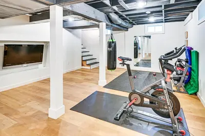 a room with a gym with a treadmill and a tv at 8 Mi to Tanglewood and Butternut Ski Spacious Home! in Housatonic