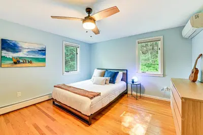 a bedroom with a bed and a ceiling fan at 8 Mi to Tanglewood and Butternut Ski Spacious Home! in Housatonic