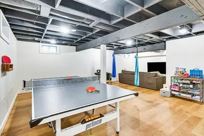 a ping pong table in a room with a couch at 8 Mi to Tanglewood and Butternut Ski Spacious Home! in Housatonic