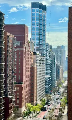 a city with tall buildings and a street with cars at Midtown Park Ave Charming Chrysler View Corner Studio in New York