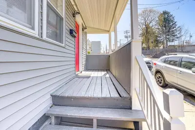 a porch of a house with a red door at Walk to Dtwn Hudson Cozy Upstate Apartment in Hudson