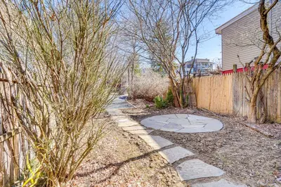 a sidewalk in a yard next to a fence at Walk to Dtwn Hudson Cozy Upstate Apartment in Hudson