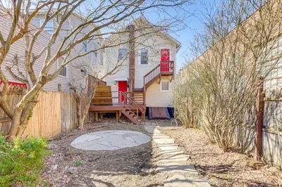 a house with a red door and a fence at Walk to Dtwn Hudson Cozy Upstate Apartment in Hudson