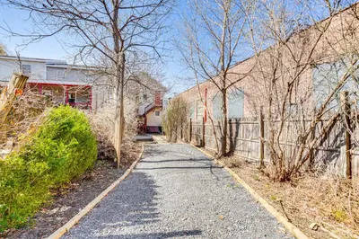 a driveway leading to a house with a fence at Walk to Dtwn Hudson Cozy Upstate Apartment in Hudson