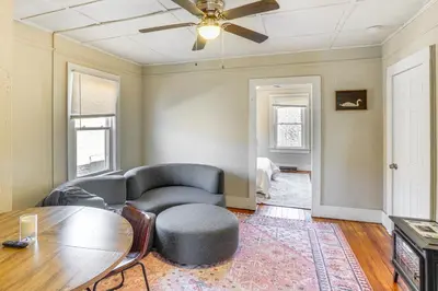 a living room with a couch and a table at Walk to Dtwn Hudson Cozy Upstate Apartment in Hudson