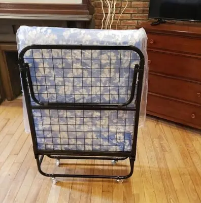 a shopping cart covered in plastic sitting on a floor at Great Looking Studio Apartment in New York