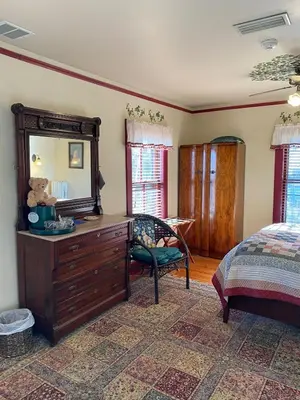 a bedroom with a dresser and a mirror at Amherst Inn in Amherst