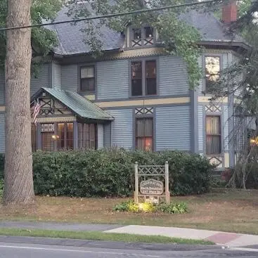 a blue house with a sign in front of it at Amherst Inn in Amherst
