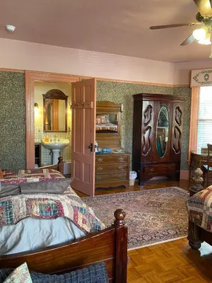 a bedroom with a bed and a sink at Amherst Inn in Amherst