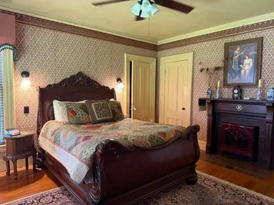 a bedroom with a large bed and a fireplace at Amherst Inn in Amherst