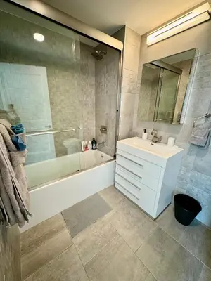 a bathroom with a tub and a sink and a shower at Peaceful Quiet Spacious New Modern Penthouse 3-Bedroom Apartment with a Balcony in Brooklyn