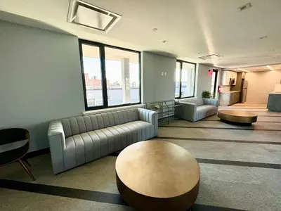 a living room with a couch and a table at Peaceful Quiet Spacious New Modern Penthouse 3-Bedroom Apartment with a Balcony in Brooklyn