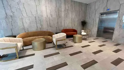 a lobby with a couch and chairs in a room at Peaceful Quiet Spacious New Modern Penthouse 3-Bedroom Apartment with a Balcony in Brooklyn