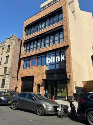 a building with a bmw car parked in front of it at Peaceful Quiet Spacious New Modern Penthouse 3-Bedroom Apartment with a Balcony in Brooklyn