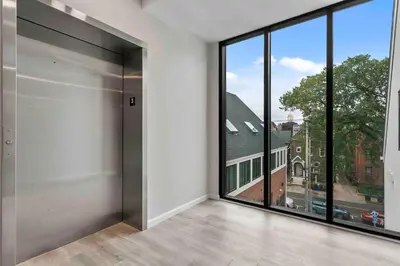 an empty room with a large window with a view at Stylish Comfort Wooster Square Yale Wi-Fi in New Haven