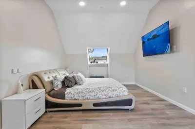 a bedroom with a large bed in the corner at Stylish Comfort Wooster Square Yale Wi-Fi in New Haven