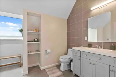 a bathroom with a toilet and a sink and a window at Stylish Comfort Wooster Square Yale Wi-Fi in New Haven