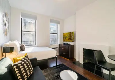 a hotel room with a bed and a fireplace at Studio for 2! Heart of Midtown! in New York
