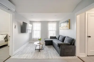 a living room with a couch and a table at 2 Bed Apt in BlackRock by beach in Bridgeport