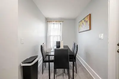 a dining room with a table and chairs and a window at 2 Bed Apt in BlackRock by beach in Bridgeport