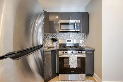 a kitchen with a stainless steel stove and microwave at Lrg 2 Bedroom apart in BlackRock in Bridgeport