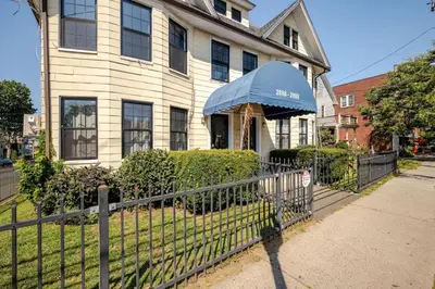 a house with a fence in front of it at Lrg 2 Bedroom apart in BlackRock in Bridgeport