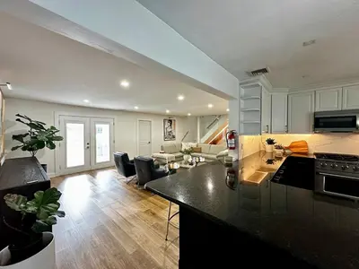 a kitchen and a living room with a counter top at Luxurious Home Away from Home ! 30 minutes to NYC ! in Rochelle Park