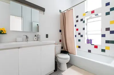 a bathroom with a sink and a toilet and a tub at XL Prime Tribeca Furnished Loft, June To Aug 90 Days Stay Required in New York