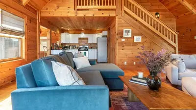 a living room with blue chairs and a table at Secluded w Deck Views Hot Tub Ping Pong Hudson in the Berks by AvantStay in East Chatham