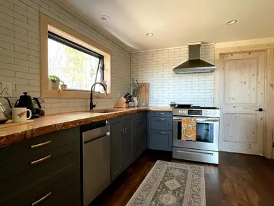 a kitchen with a sink and a stove at The A-Frame at Harvest Moon Acres in Stamford