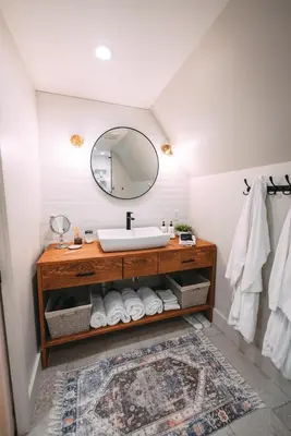 a bathroom with a sink and a mirror at The A-Frame at Harvest Moon Acres in Stamford