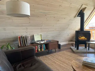 a living room with a couch and a fireplace at The A-Frame at Harvest Moon Acres in Stamford