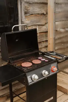 a grill with hamburgers on top of it at Rustic Escape UTV, Tub, Trails & Fire Pit 25 acre in Roscoe