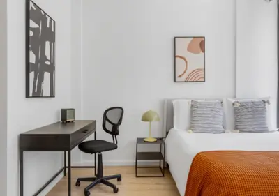 a bedroom with a bed and a desk and a chair at Awesome Sunny Studio! Best Location! in New York