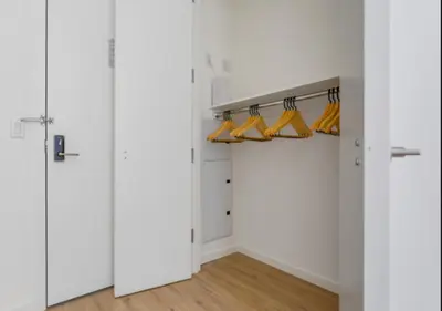 a walk in closet with white walls and yellow shoes at Awesome Sunny Studio! Best Location! in New York