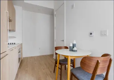 a small kitchen with a table and chairs at Awesome Sunny Studio! Best Location! in New York