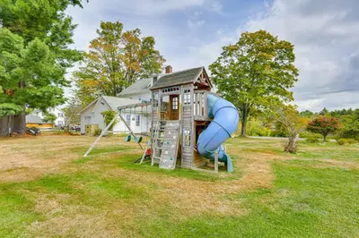 a play house with a slide in a yard at Game Room, Yard and Fire Pit Spacious Catskills Gem in Sparrow Bush