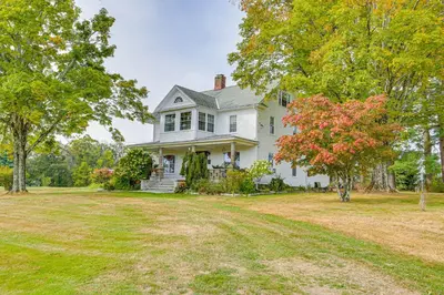 an old white house with a tree in the yard at Game Room, Yard and Fire Pit Spacious Catskills Gem in Sparrow Bush