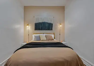 a bedroom with a large bed with two lamps at Upper West Side Furnished 1 Bedroom Apartment, June to Aug 90 days stay required in New York