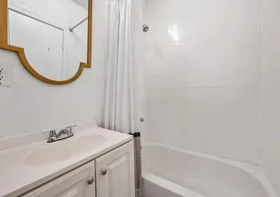 a bathroom with a sink and a tub and a mirror at Upper West Side Furnished 1 Bedroom Apartment, June to Aug 90 days stay required in New York