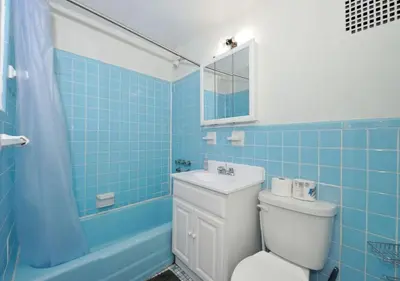 a bathroom with a toilet and a sink and a tub at Charming UES Studio, Walk to Subway & Central Park, June To Aug 90 Days Stay Required in New York