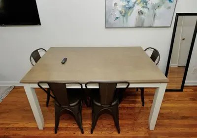 a wooden table with black chairs around it at Charming UES Studio, Walk to Subway & Central Park, June To Aug 90 Days Stay Required in New York