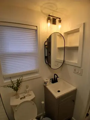 a bathroom with a toilet and a sink and a mirror at Monthly Stays - 2BR Apt in Bloomfield - 8 Min Walk from NJ Transit in Bloomfield