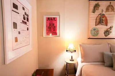 a bedroom with a bed and some pictures on the wall at Artistic Vintage Loft in Williamsburg in Brooklyn